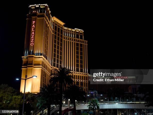 The letters of the resort names at the shuttered Palazzo Las Vegas and The Venetian Las Vegas are lit red as part of a "red takeover" coinciding with...