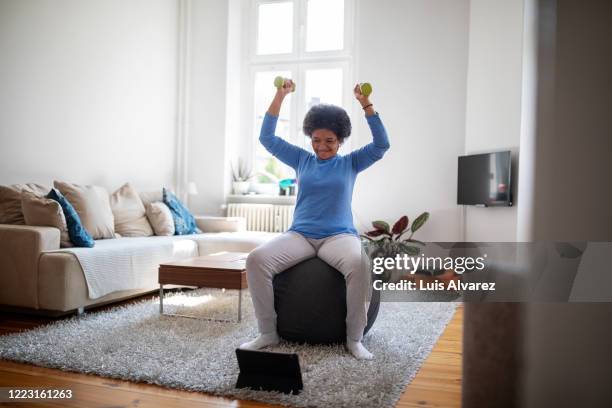 woman is doing online workout during covid-19 lockdown - sport train covid stockfoto's en -beelden