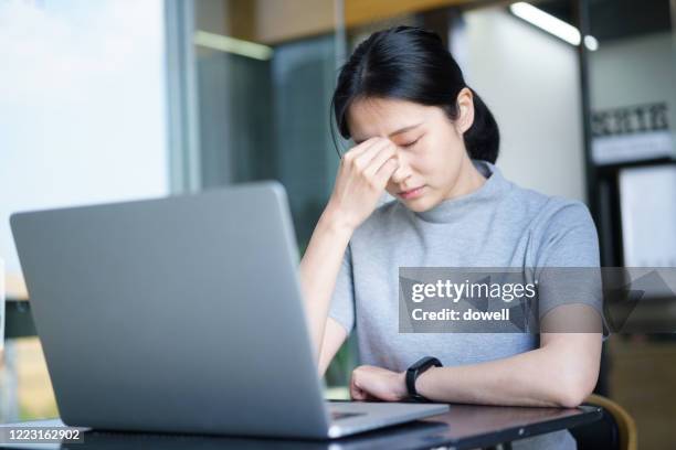 asian female relaxing in office - 目 ストックフォトと画像