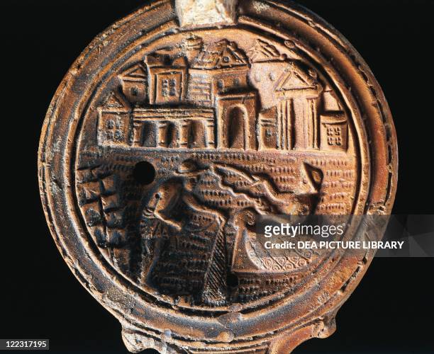 Roman civilization, 1st century A.D. Terracotta oil lamp with relief depicting the Port of Alexandria with the tomb of Alexander and the Mausoleum of...