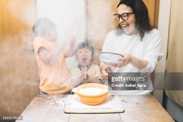 family making cookies at home - asian mother cooking imagens e fotografias de stock