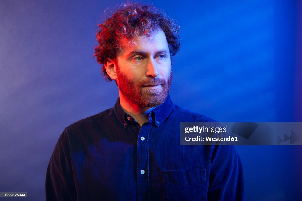 Portrait of a man at a blue wall