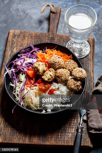 bowl ofready-to-eatsalad with white and red cabbage, carrots, rice and spinach falafel - falafel stock pictures, royalty-free photos & images