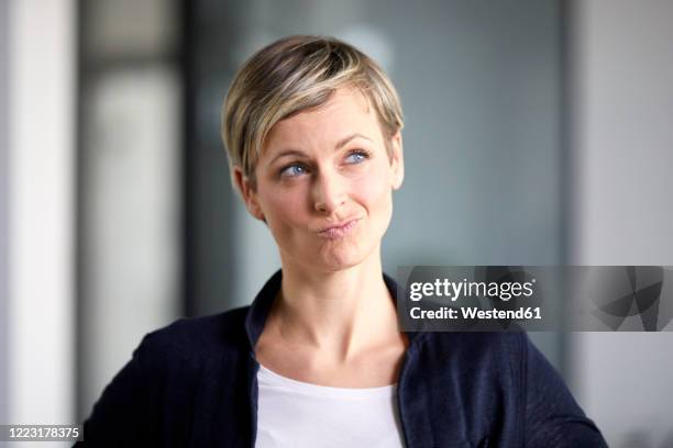 portrait of a pensive businesswoman in office - suspicion office stock pictures, royalty-free photos & images