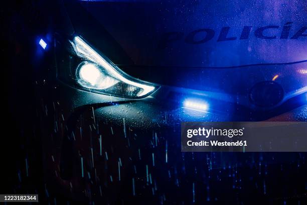 spain, madrid, hood of police car driving in middle of rainy night - rain night ストックフォトと画像