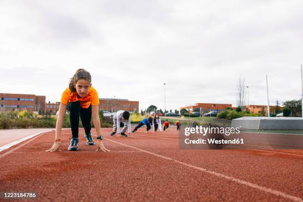 children in starting postion, preparing for a race - kids track and field stock pictures, royalty-free photos & images