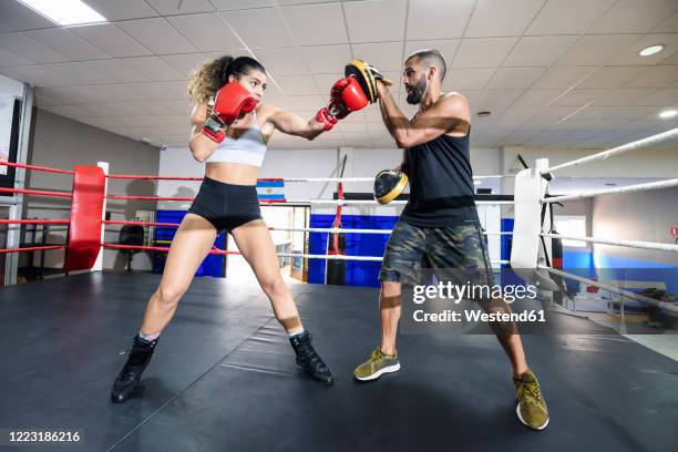 female boxer sparring with her coach in gym - womens boxing 個照片及圖片檔