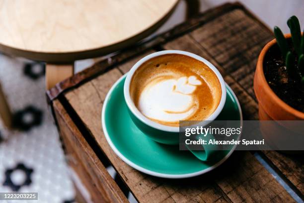 cup of coffee on a wooden table - blue cup stock pictures, royalty-free photos & images