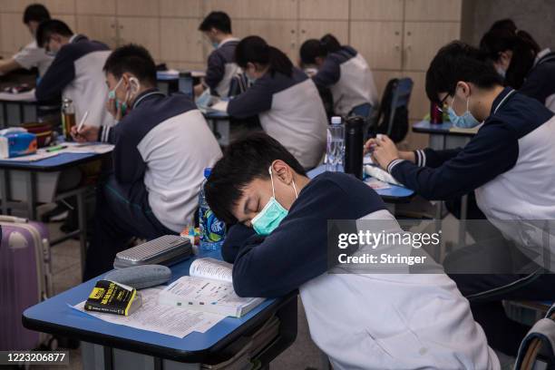 Senior students wear a mask while have rest in a classroom No. 6 Middle School on May 6, 2020 in Wuhan, Hubei Province, China .About 57,800 students...