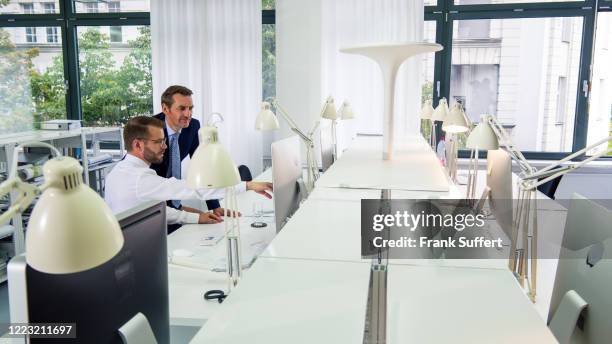 two men working in the office - communications director stock pictures, royalty-free photos & images