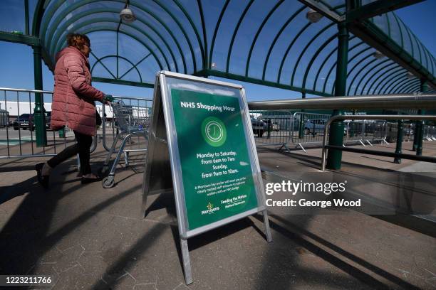 General view of a sign advertising the Shopping hour for NHS workers outside a Morrisons supermarket on May 06, 2020 in Bradford, England. The UK is...