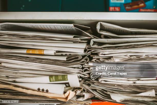 newspaper on cupboard for recycling - sala de prensa fotografías e imágenes de stock