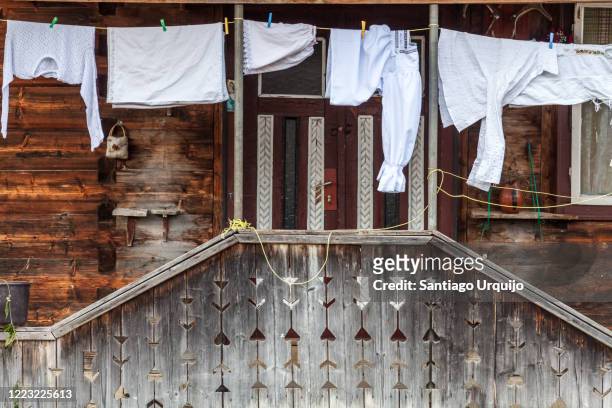 laundry hanging in porch of wooden house - maramureș stock pictures, royalty-free photos & images