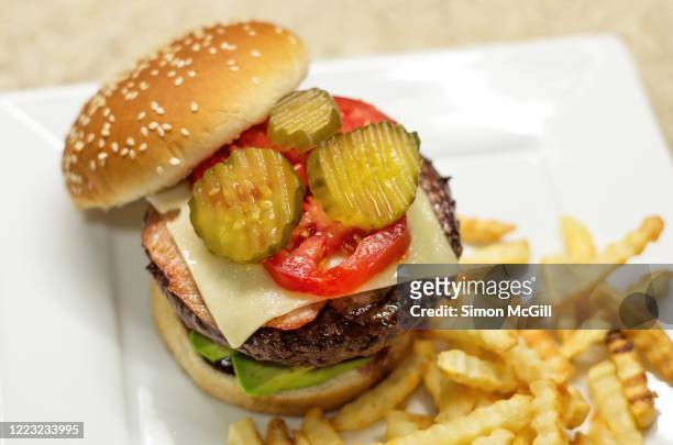 homemade hamburger with crinkle cut chips on a white plate - inlagd gurka bildbanksfoton och bilder