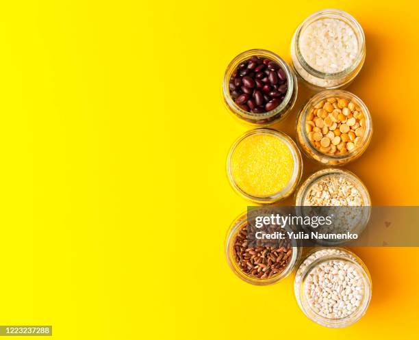 top view of a set of various cereals and grains on the yellow background. - buckwheat isolated stock pictures, royalty-free photos & images