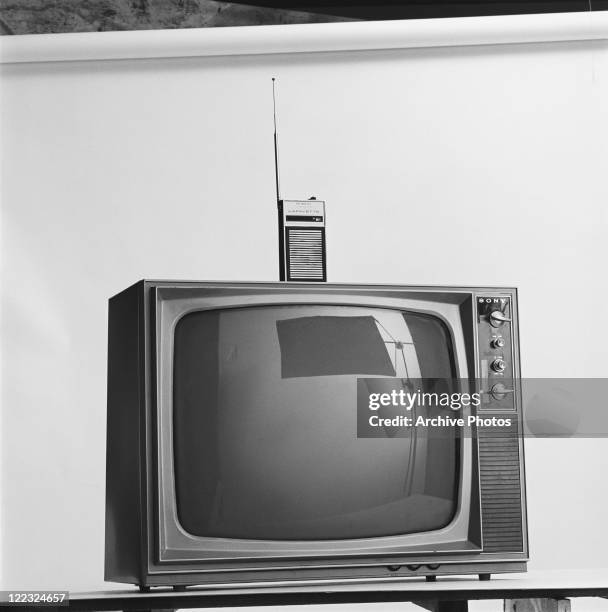 Vintage television and transmitter against white background