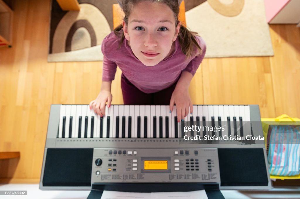 Girl playing piano at home
