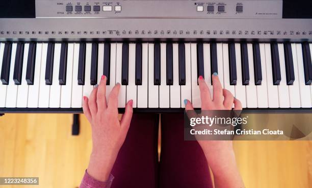 a child playing piano - keyboard player fotografías e imágenes de stock