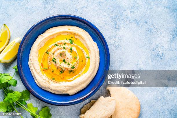 vegan food: hummus in a plate with pita bread. copy space - blue plate stock pictures, royalty-free photos & images