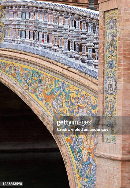 ornate foot bridge at the plaza de españa in seville, spain - seville palace stock pictures, royalty-free photos & images