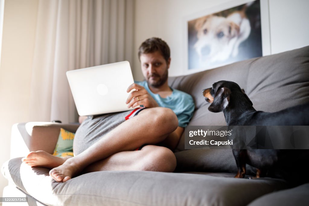 Dog barking at his owner while he works