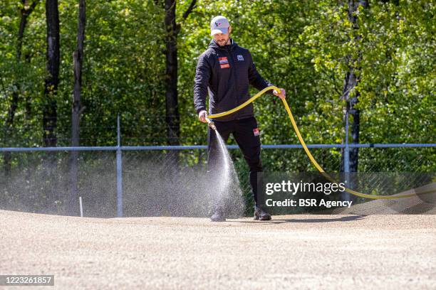 Head coach Raymon van der Biezen is spraying the track with water at the Dutch top BMX riders first training at Papendal training centre after the...