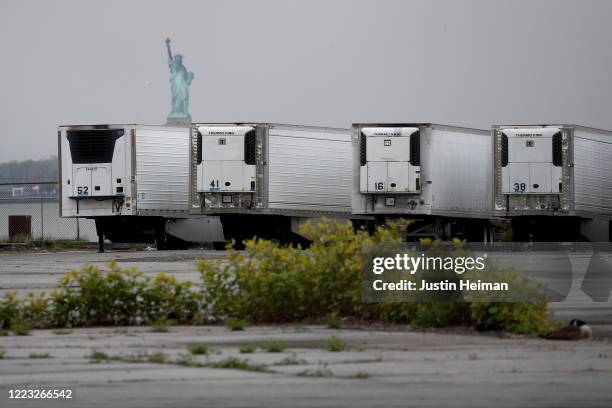 Refrigerated trucks functioning as temporary morgues are seen at the South Brooklyn Marine Terminal on May 06, 2020 in the Brooklyn borough of New...