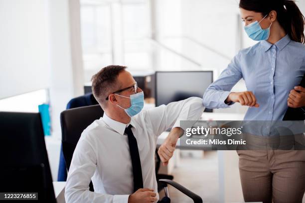 business people greeting during covid-19 pandemic stock photo - elbow greeting stock pictures, royalty-free photos & images