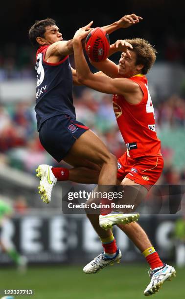 Neville Jetta of the Demons and Maverick Weller of the Suns contest for a mark during the round 23 AFL match between the Melbourne Demons and the...