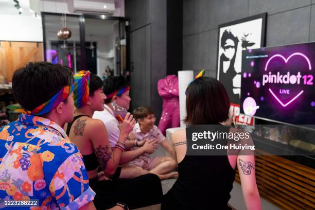 People gather to watch the Pink Dot SG rally livestream in a house on June 27, 2020 in Singapore. Due to the ongoing coronavirus pandemic, this years...