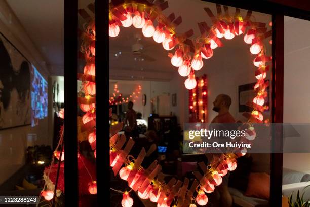 Pink light is displayed in a house, in a show of support to the LGBTQ community on June 27, 2020 in Singapore. Due to the ongoing coronavirus...