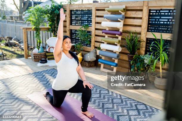 prenatal yoga outside on deck - prenatal yoga stock pictures, royalty-free photos & images