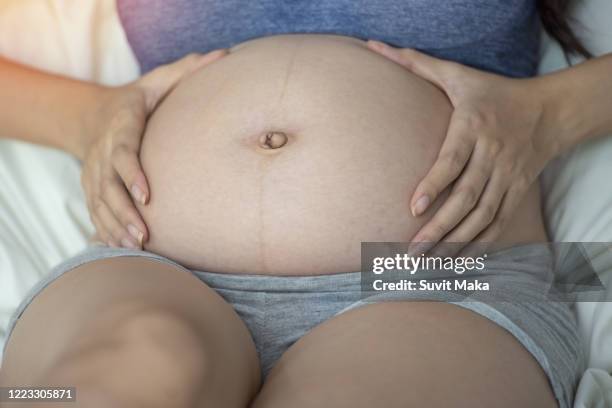 happy pregnant woman with big belly. - pregnant belly stockfoto's en -beelden