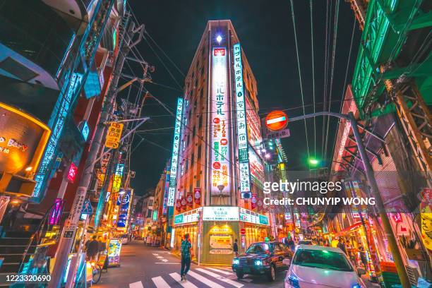 tokyo rush hour commuters neon night streets of shimbashi japan - ginza stock pictures, royalty-free photos & images