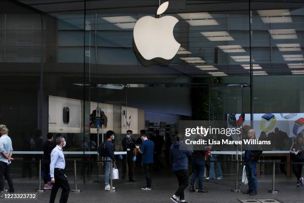 Apple staff members assist customers on the street prior to entering the Bondi Junction store on May 07, 2020 in Sydney, Australia. Apple stores...