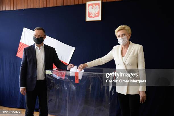 Polish President of the right-wing Law and Justice party Andrzej Duda and his wife, Agata Kornhauser Duda, cast their ballots in Poland's...