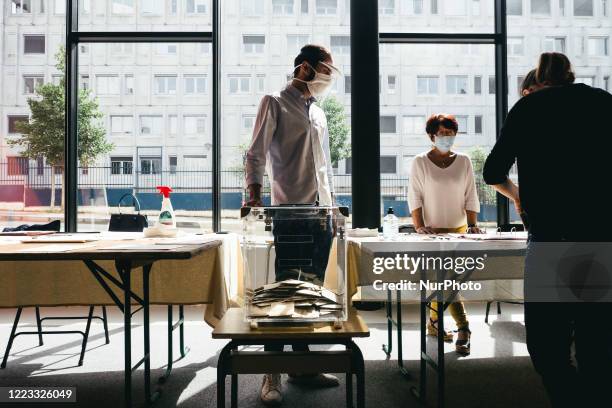 View of a Rennes polling station during the second round of municipal elections. Accessors make the voters sign in despite the lack of mobilization....