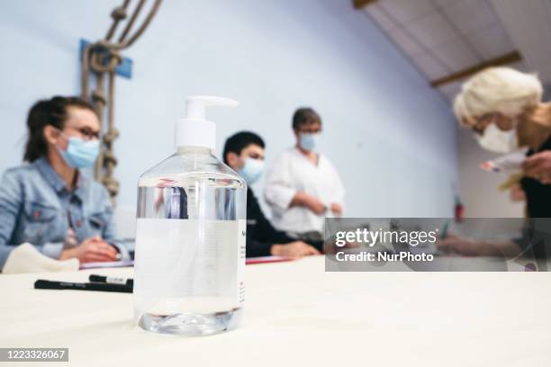 View of a polling station in Rennes during the second round of municipal elections during the coronavirus epidemic. A jar of hydroalcoholic gel is...