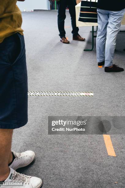 In a Rennes polling station, signs on the ground remind voters of the measures to prevent them from voting during the second round of the municipal...