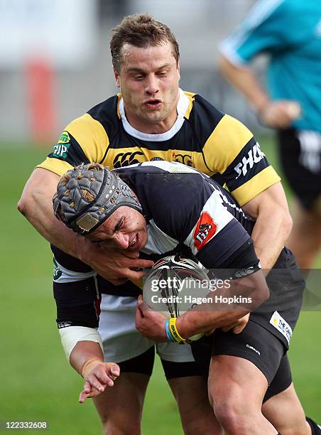 Daniel Kirkpatrick of Hawkes Bay is tackled by Tyson Keats of Taranaki during the round 13 ITM Cup match between Taranaki and Hawke's Bay at Yarrow...