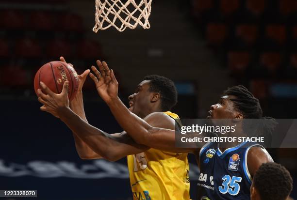 Riesen Ludwigsburg's German power forward Ariel Hukporti vies with Alba Berlin's Cameroonian center Landry Nnoko during the German basketball...