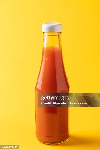 flavoring: chili sauce on a yellow background - scharfe sauce stock-fotos und bilder