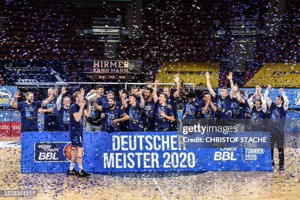 The team of Alba Berlin celebrates with the trophy after the German basketball Bundesliga final second-leg match between MHP Riesen Ludwigsburg and...