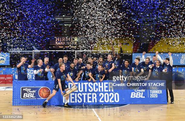 The team of Alba Berlin celebrates with the trophy after the German basketball Bundesliga final second-leg match between MHP Riesen Ludwigsburg and...