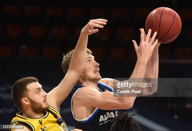 Alba Berlin's US power forward Luke Sikma and MHP Riesen Ludwigsburg's German shooting guard Radii Caisin vie for the ball during the EasyCredit...