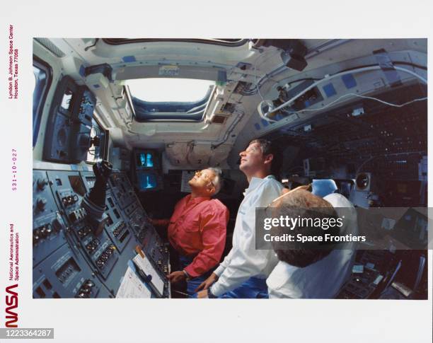 Mission crew members monitoring the Hubble Space Telescope deployment checkout procedures, from Space Shuttle Discovery, Orbiter Vehicle 103,...