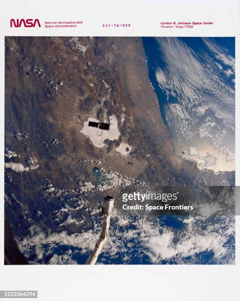 Hubble Space Telescope , with its solar array wings and high gain antennae fully extended, is released from Space Shuttle Discovery's, Orbiter...