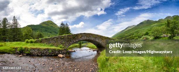 panoramic view of butter bridge over kinglas water in the loch lomond national park in scotland - the national bridge stock pictures, royalty-free photos & images