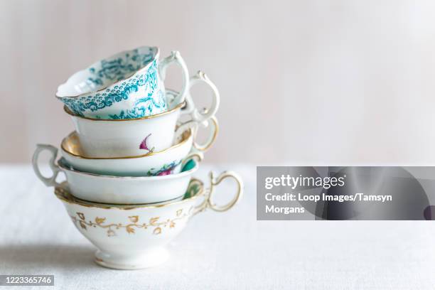 stack of vintage teacups - teatime stock pictures, royalty-free photos & images