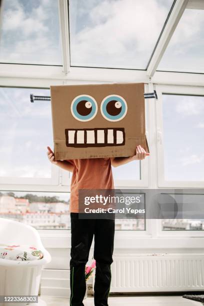 robot boy in cardboard box - traditional helmet stock pictures, royalty-free photos & images